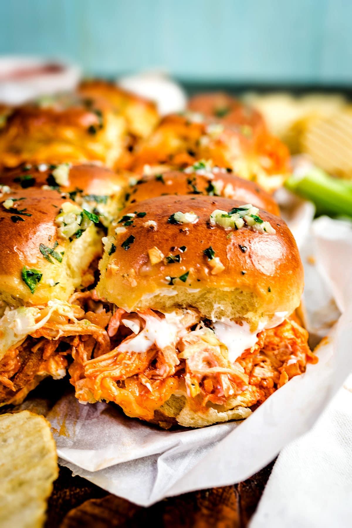 appetizing buffalo chicken sliders piled high with ranch dressing drizzle