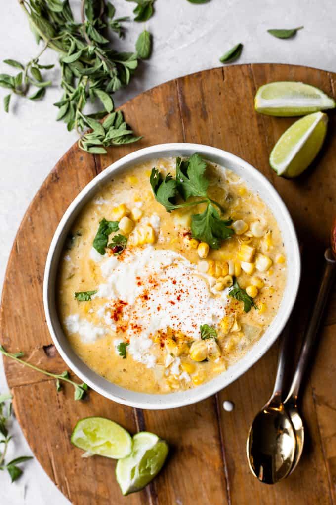 bowl of creamy Mexican street corn soup topped with cilantro and chili powder