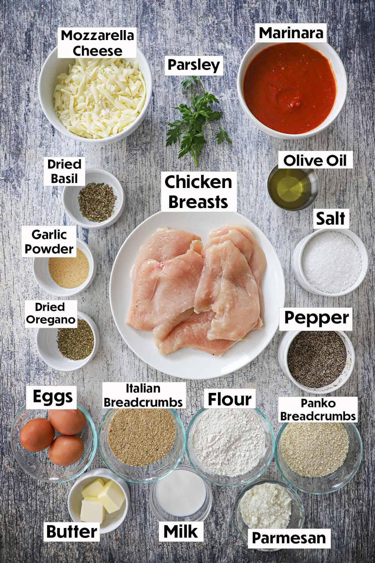 ingredients for chicken parmesan fritters laid out on a wooden countertop