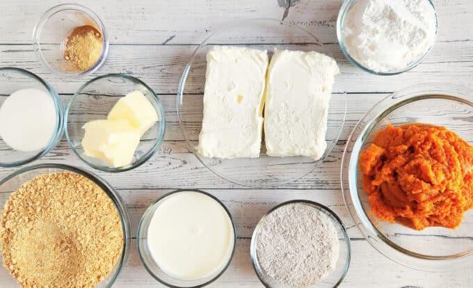 ingredients for pumpkin cheesecake laid out on a kitchen counter