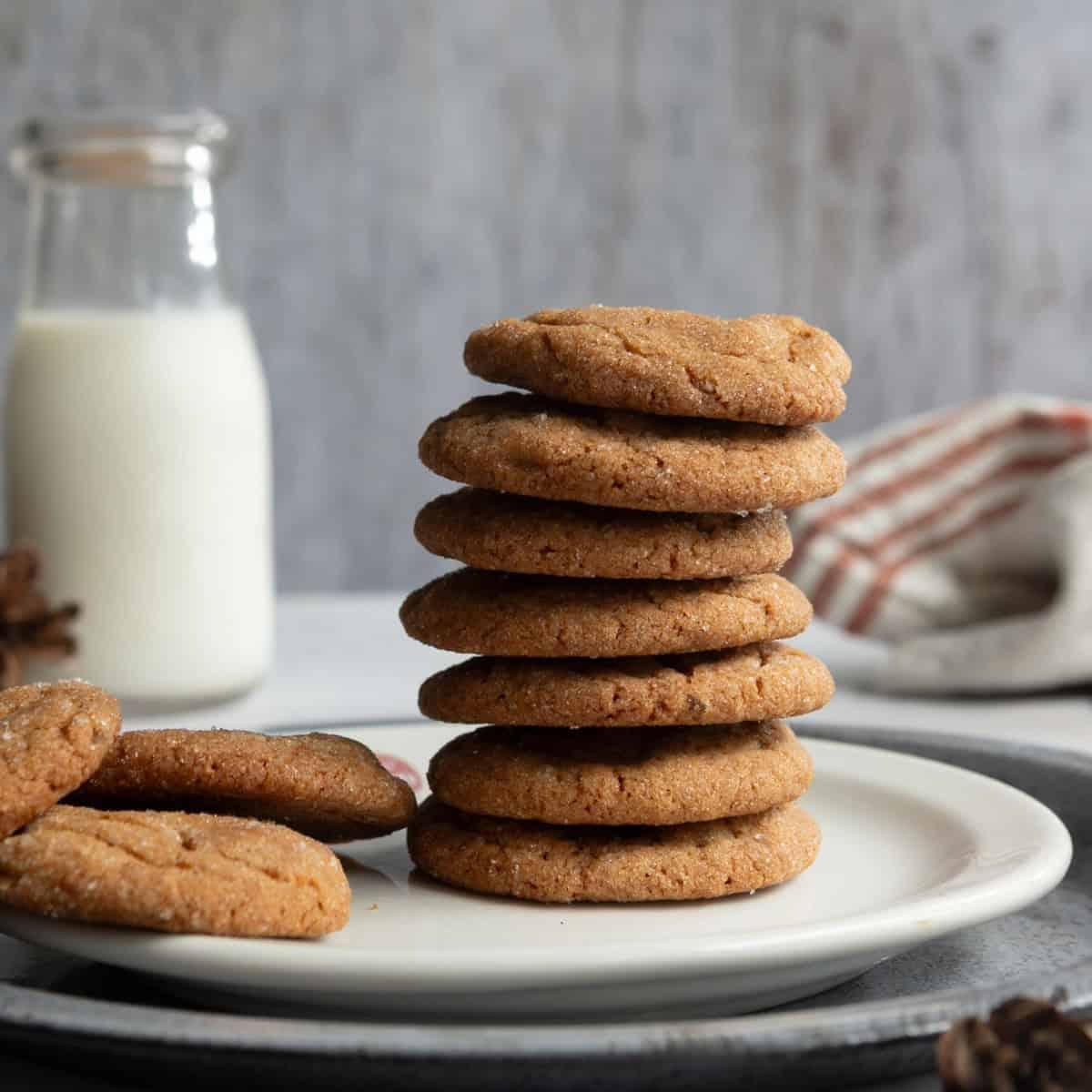 Delicious soft iced ginger cookies arranged beautifully on a rustic wooden platter with a cup of tea