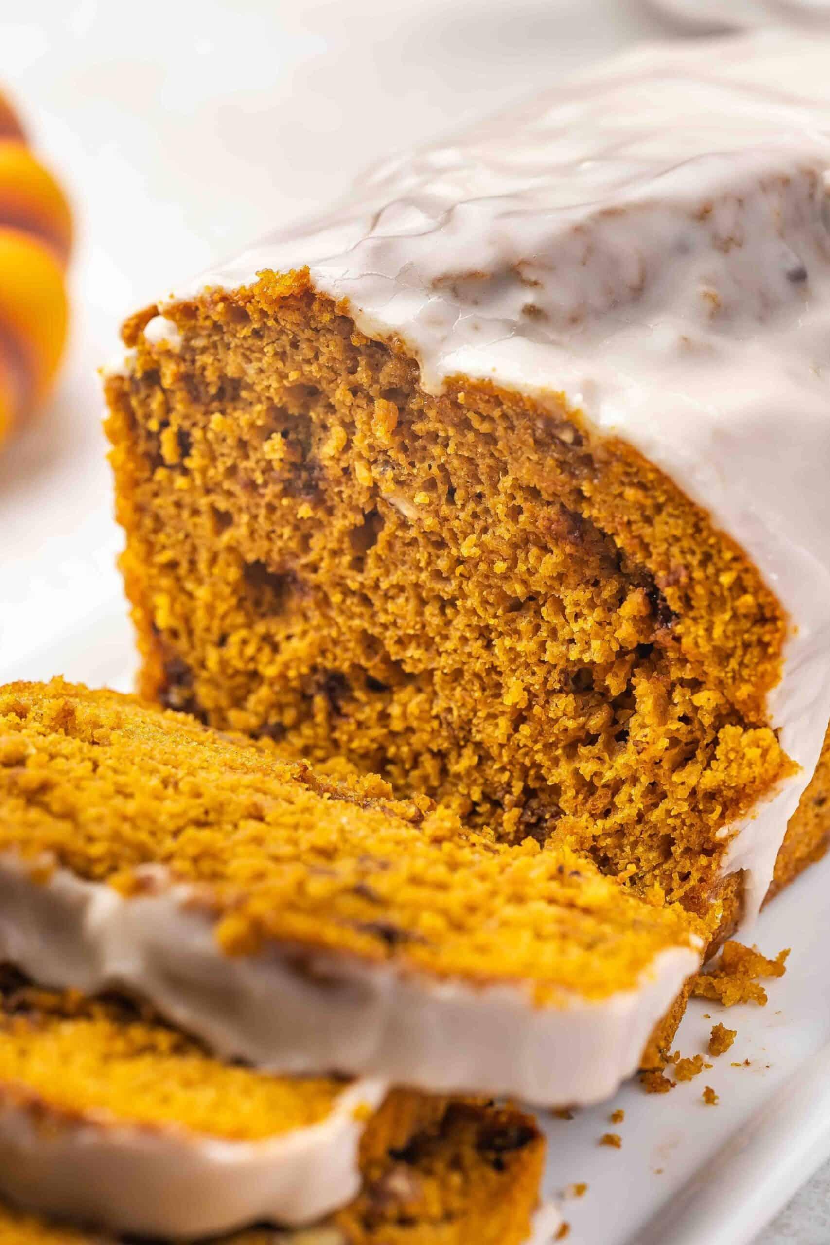close up of a slice of moist pumpkin bread with visible spices