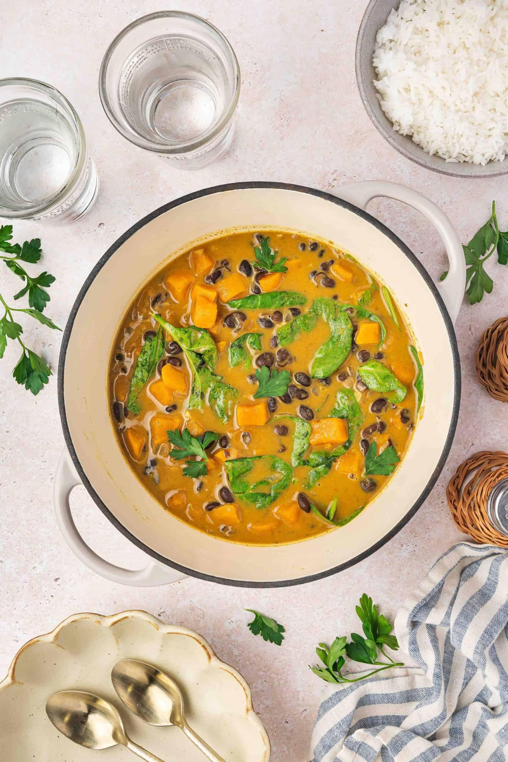 vibrant sweet potato coconut curry simmering in a pot, warm and inviting
