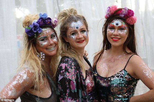 girl covered in glitter at a music festival looking annoyed