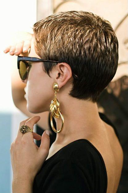 woman wearing single statement earring with edgy hairstyle