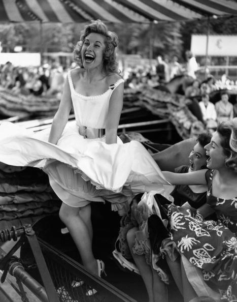 woman's dress blowing up in the wind at a festival