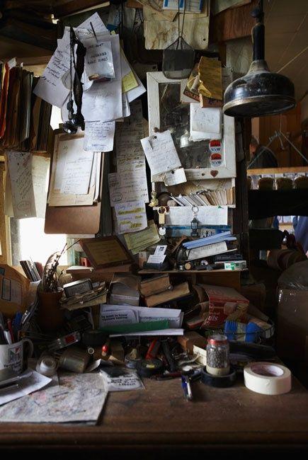 messy dorm desk cluttered with books and papers