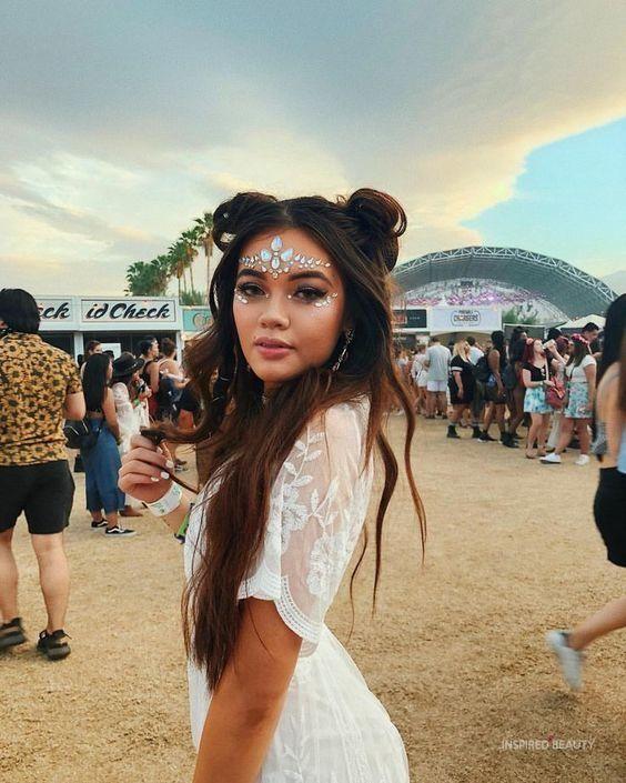 woman with perfect Coachella makeup looking happy at a music festival