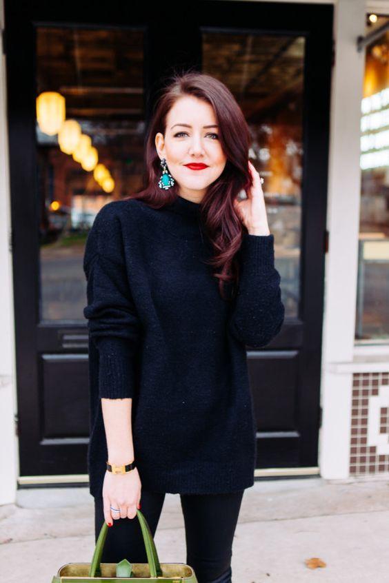 woman wearing statement earrings with a winter outfit