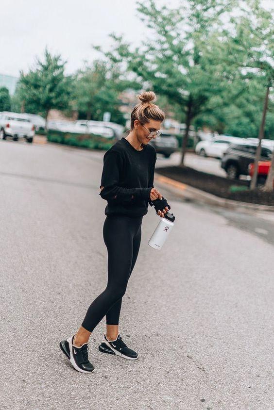 woman in stylish workout clothes exercising outdoors