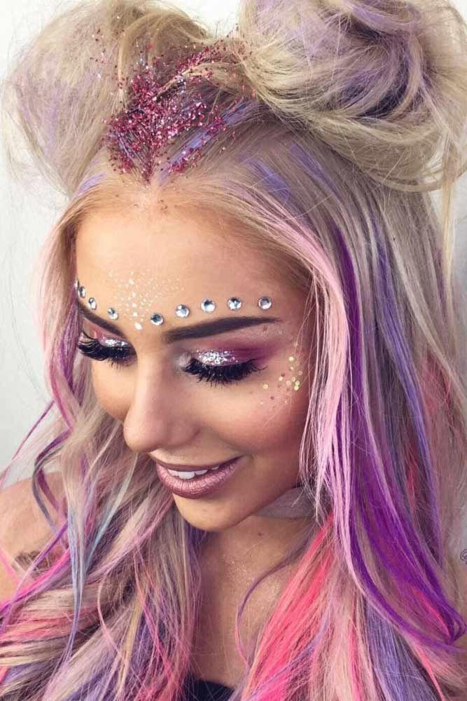 woman with a unicorn-inspired glitter makeup look at Coachella
