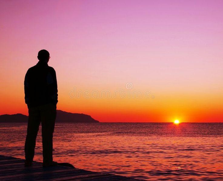 person looking at a sunset