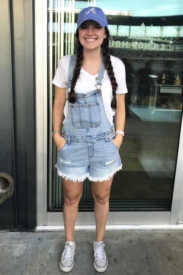 woman in jumpsuit at a baseball game