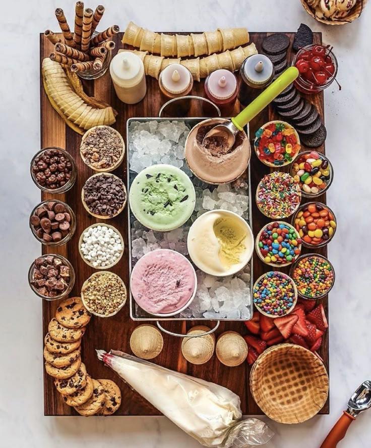 a platter of beautifully arranged rosewater almond ice cream sandwiches on a rustic wooden table
