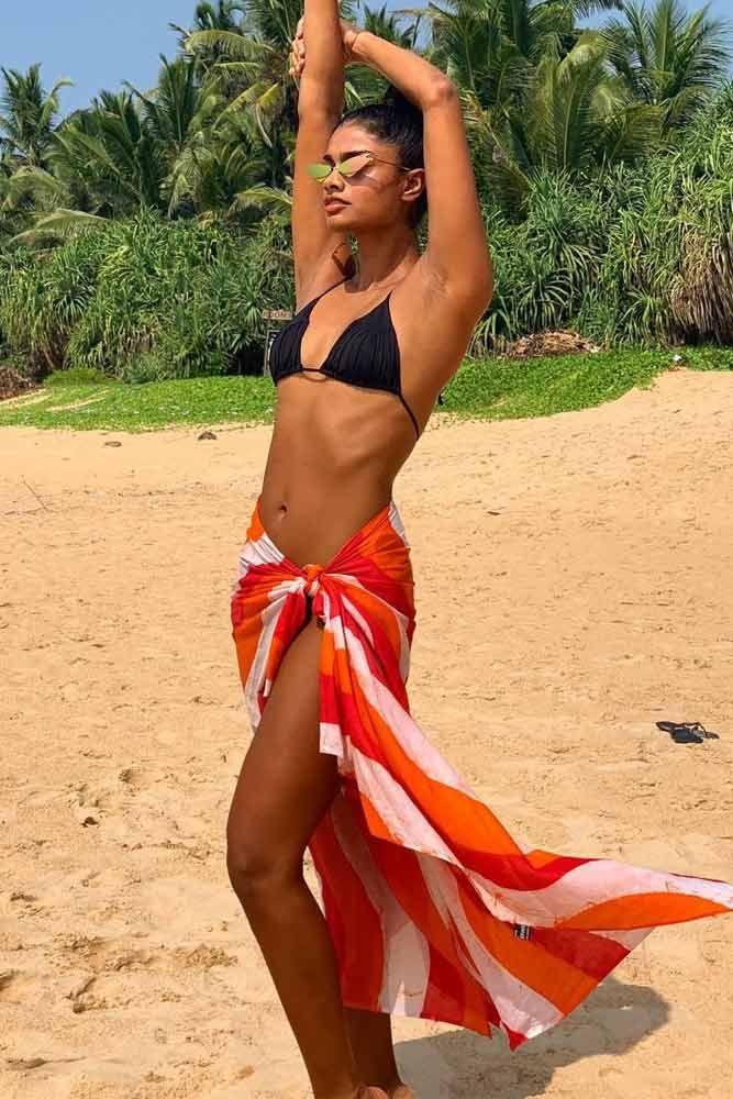 woman wearing a stylish swimsuit and sarong at the beach