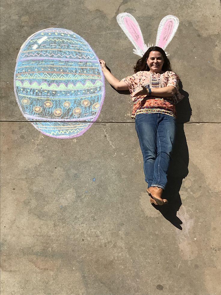 woman creating easter chalkboard art on her patio