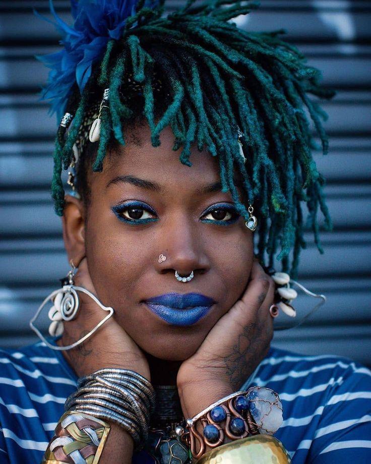 woman with short dreadlocks smiling