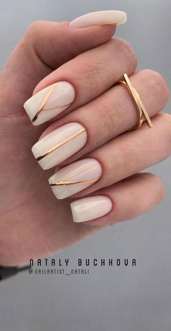 Nude nails with gold stripes