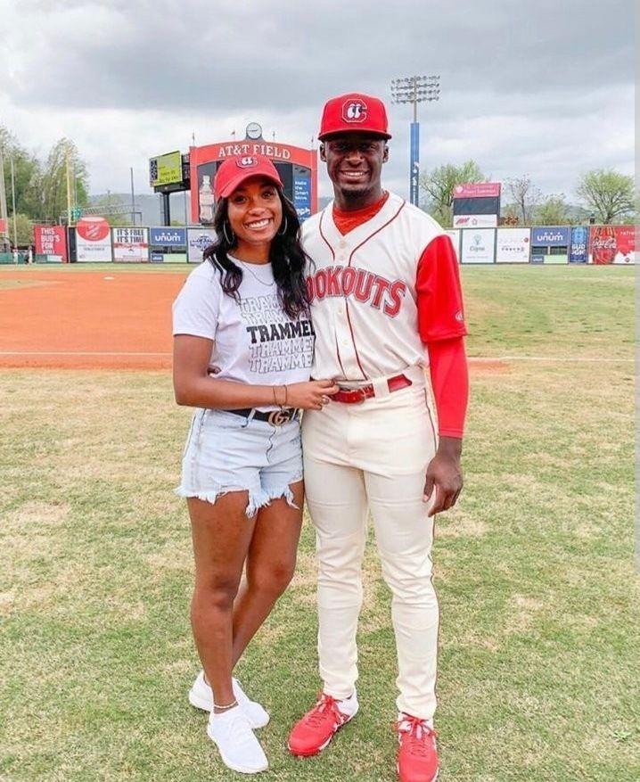 woman in stylish baseball outfit at a baseball game