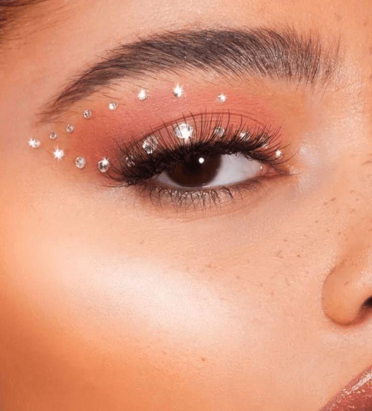 close up of eye makeup with glitter and rhinestones