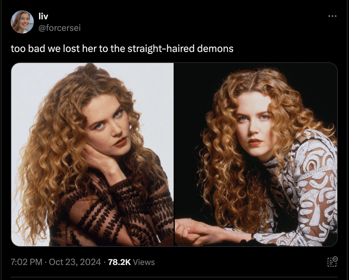 woman admiring her natural curls