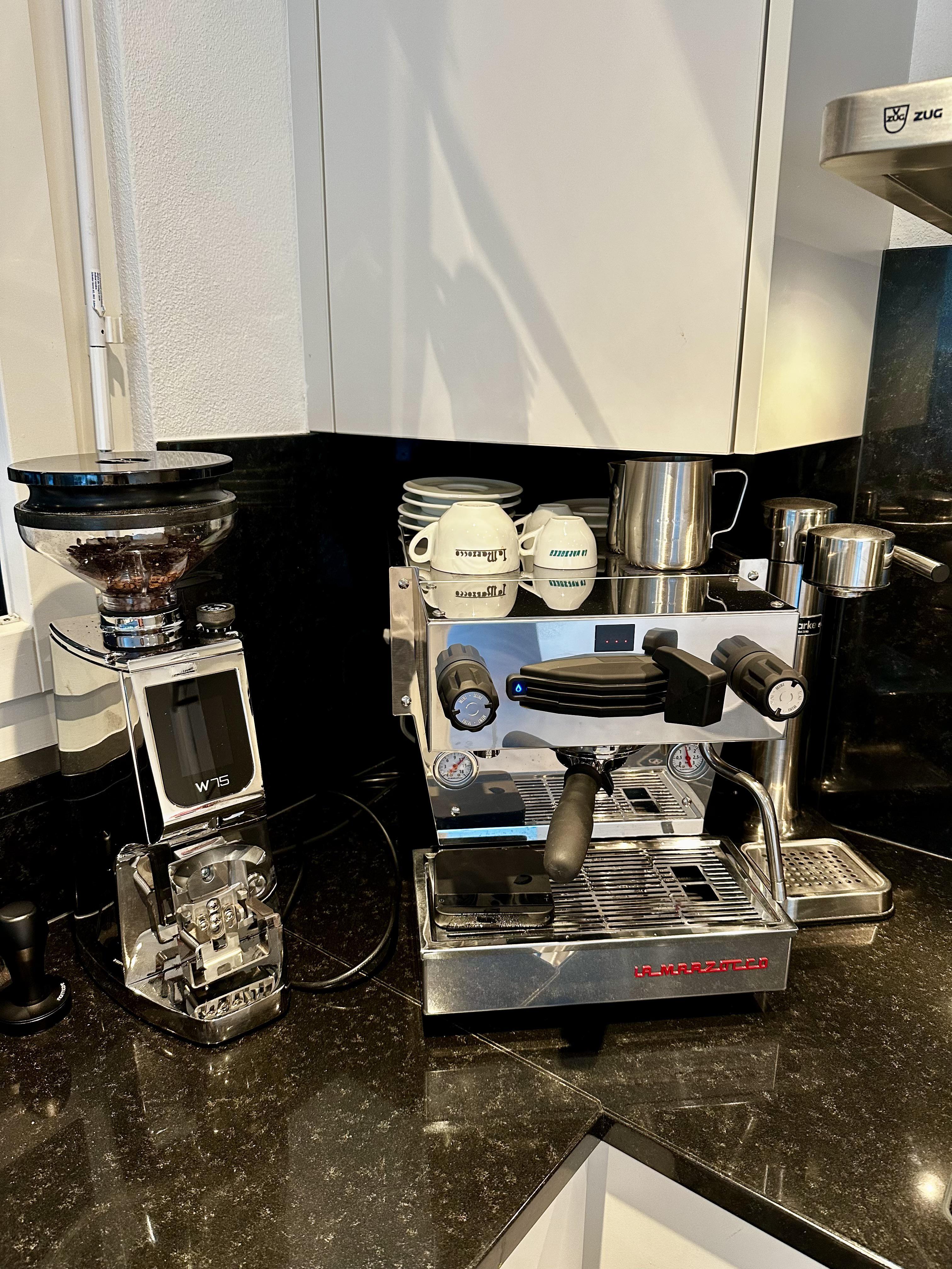 A student using a compact coffee maker in their dorm room