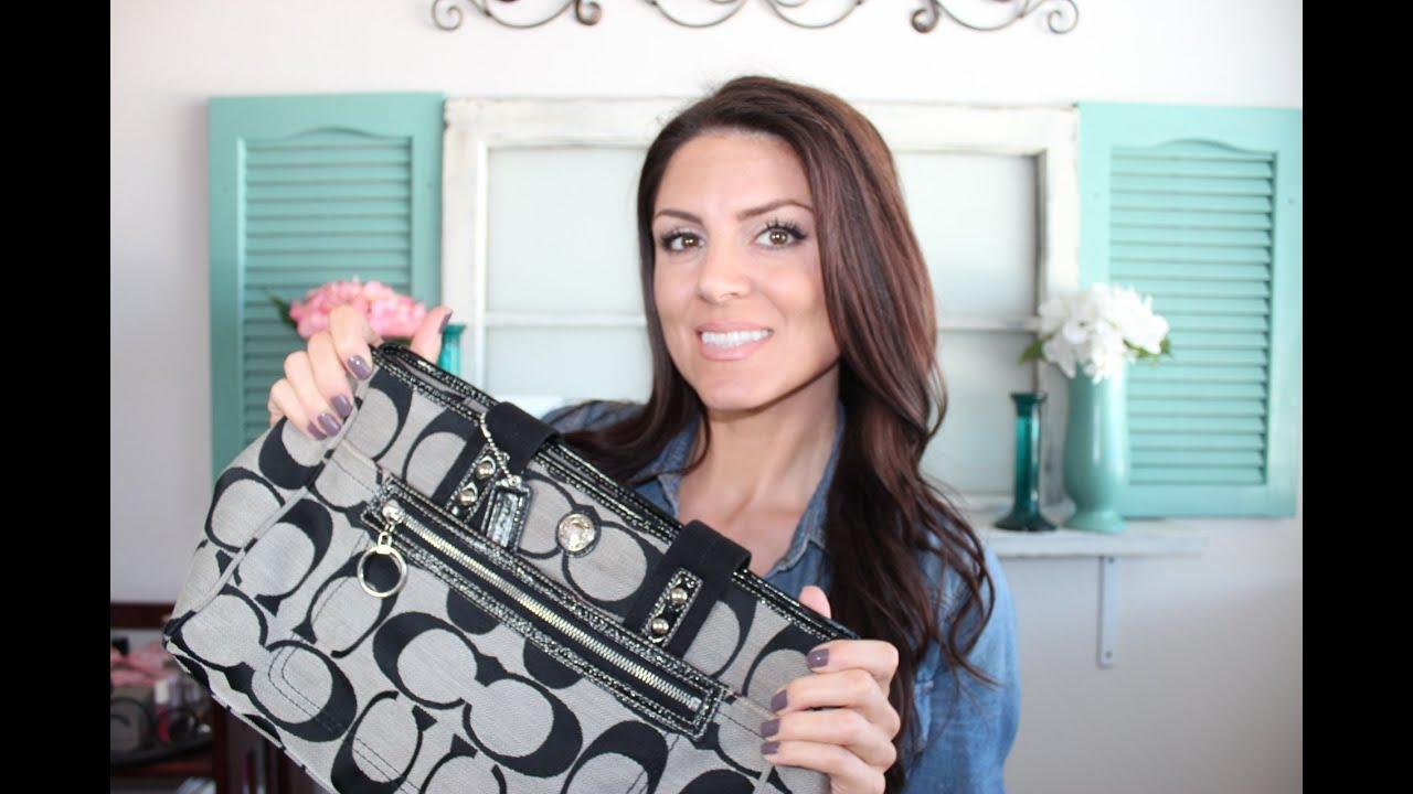 woman gently cleaning a designer handbag with a soft cloth