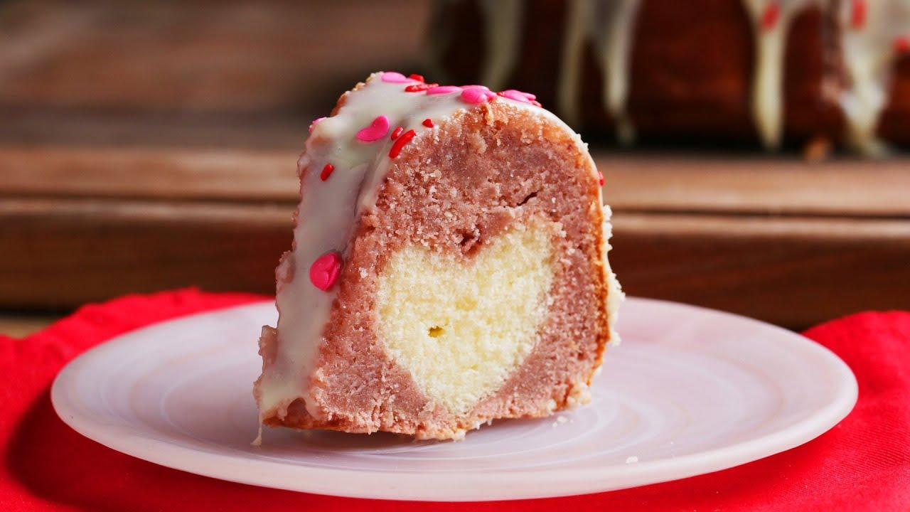 close up shot of a slice of Hidden Strawberry Heart Cake being cut