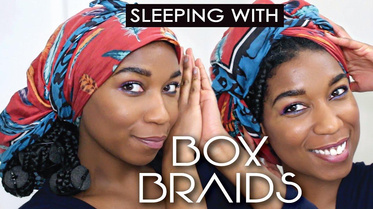 woman sleeping with a satin scarf on her braided hair