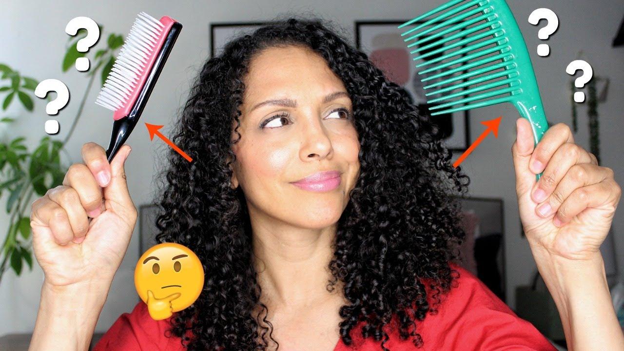 woman using a wide-tooth comb on her curly hair