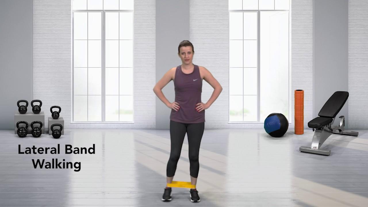 woman walking sideways with resistance band around ankles