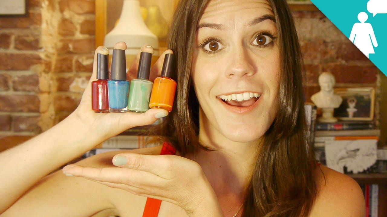 woman painting her nails with a bright color polish