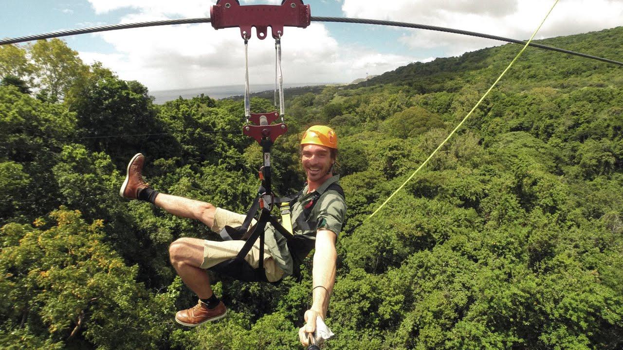 person ziplining through a rainforest