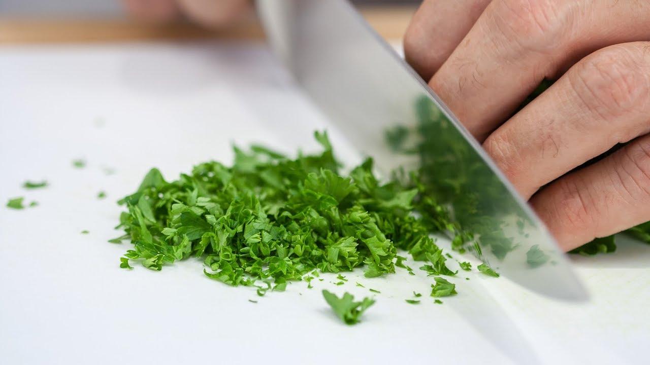 garlic being minced and fresh parsley being chopped