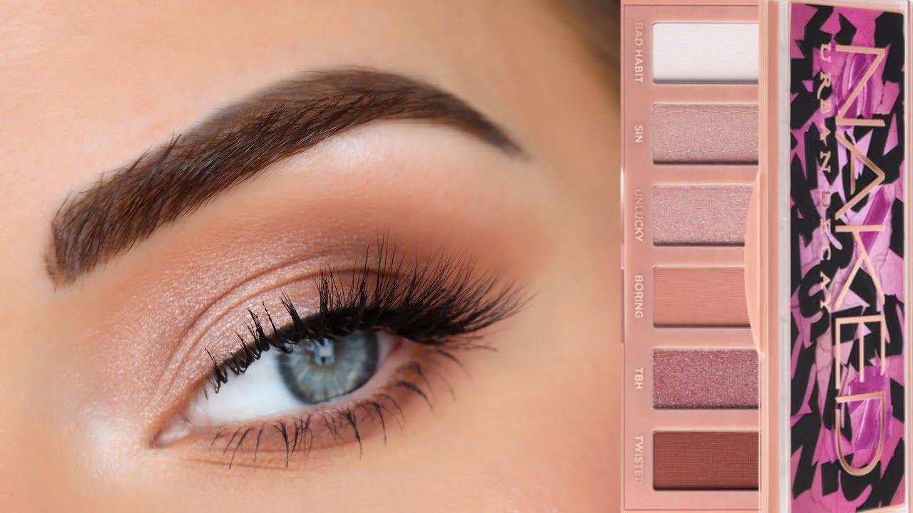 woman applying neutral eyeshadow with different brushes