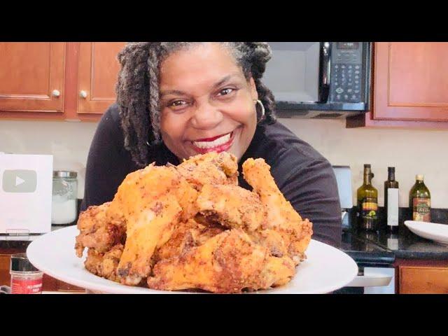 woman smiling holding crispy air fried chicken wings