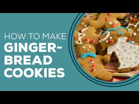 Little girl and adult baking gingerbread cookies together, flour on faces