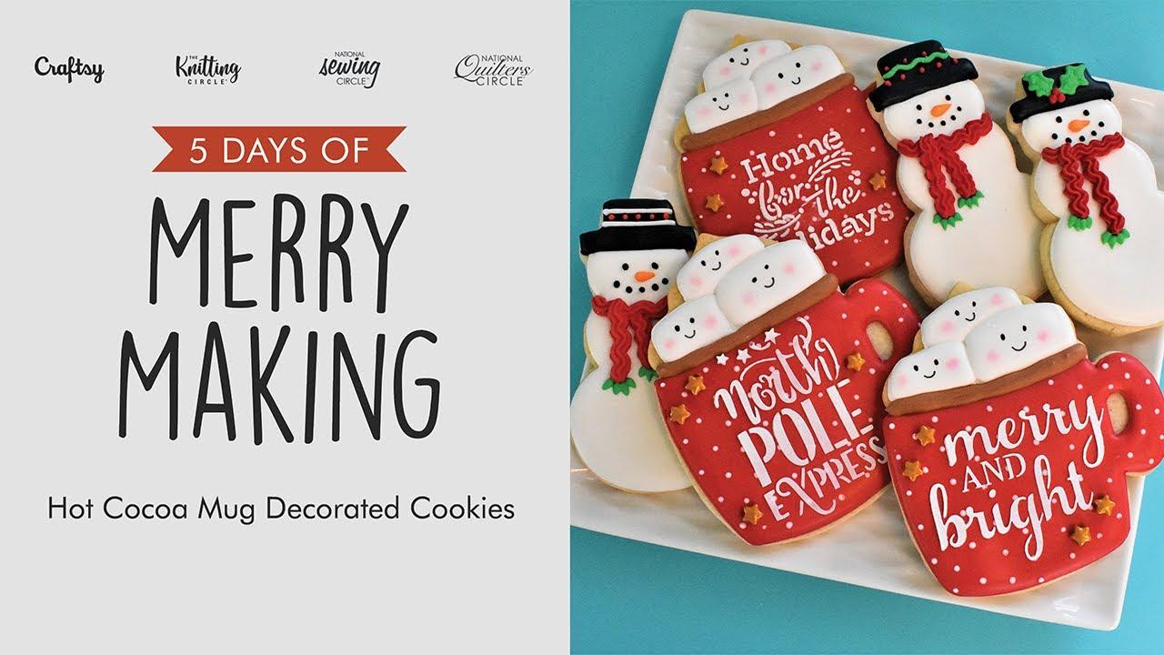 Platter of beautifully decorated sparkling sugar cutout cookies with a hot cocoa mug