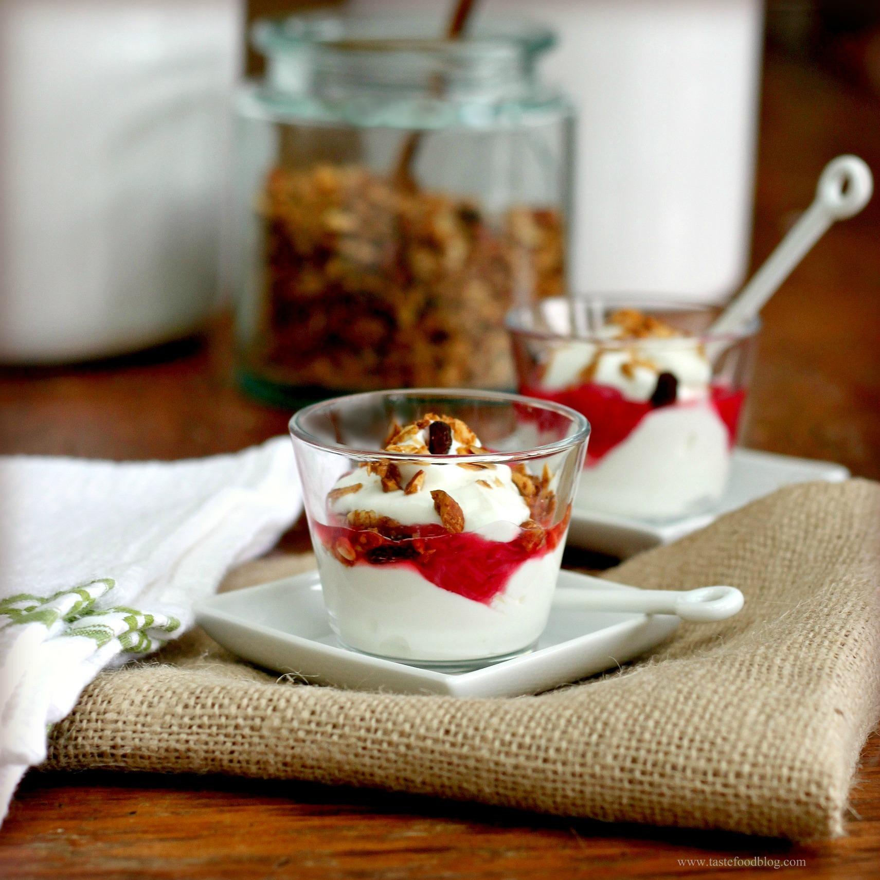 person carefully folding rhubarb compote into greek yogurt and other ingredients
