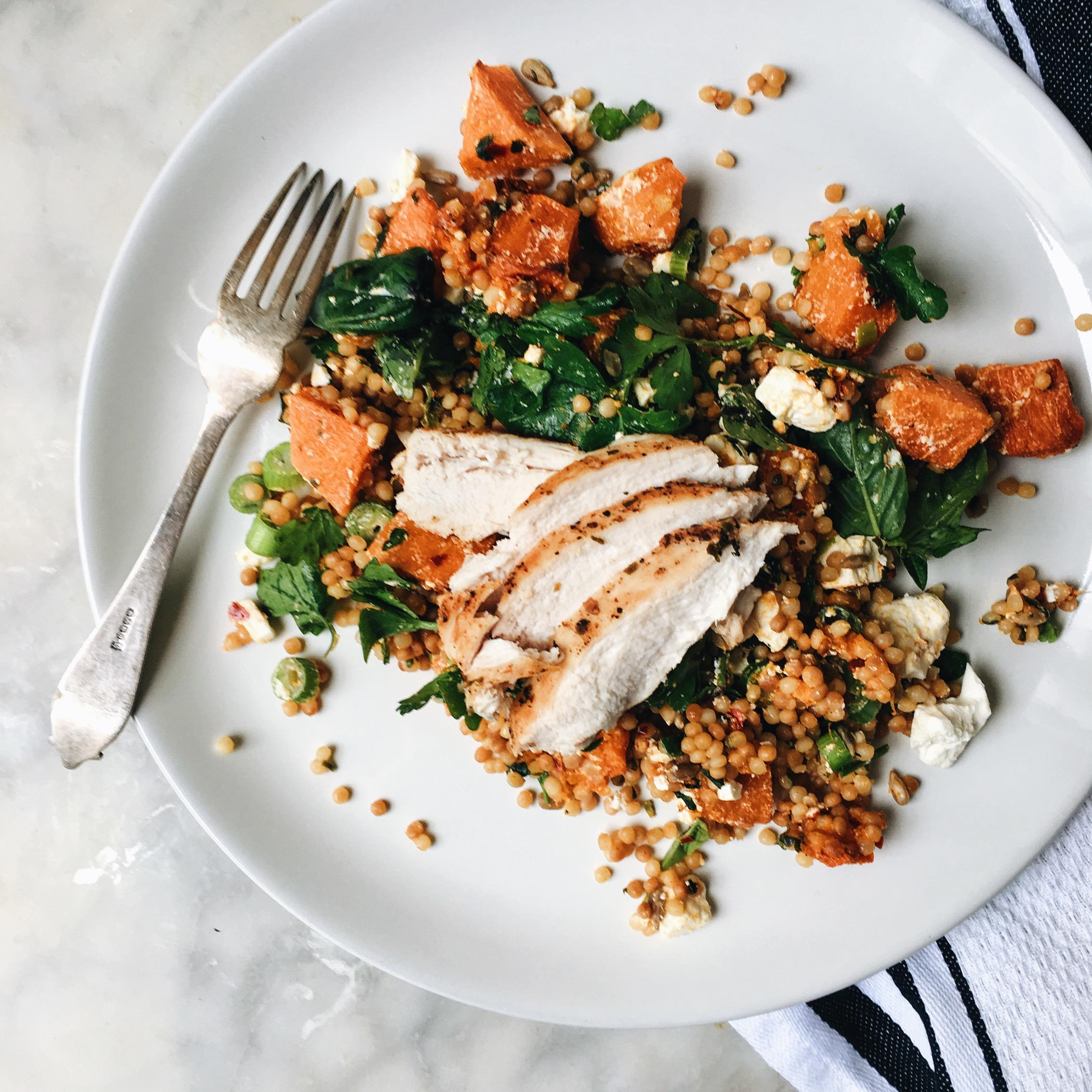 bowl of grilled chicken and couscous salad being served