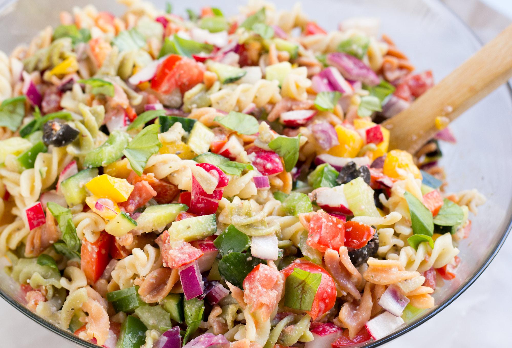 A vibrant bowl of pasta salad with colorful vegetables and a delicious dressing.