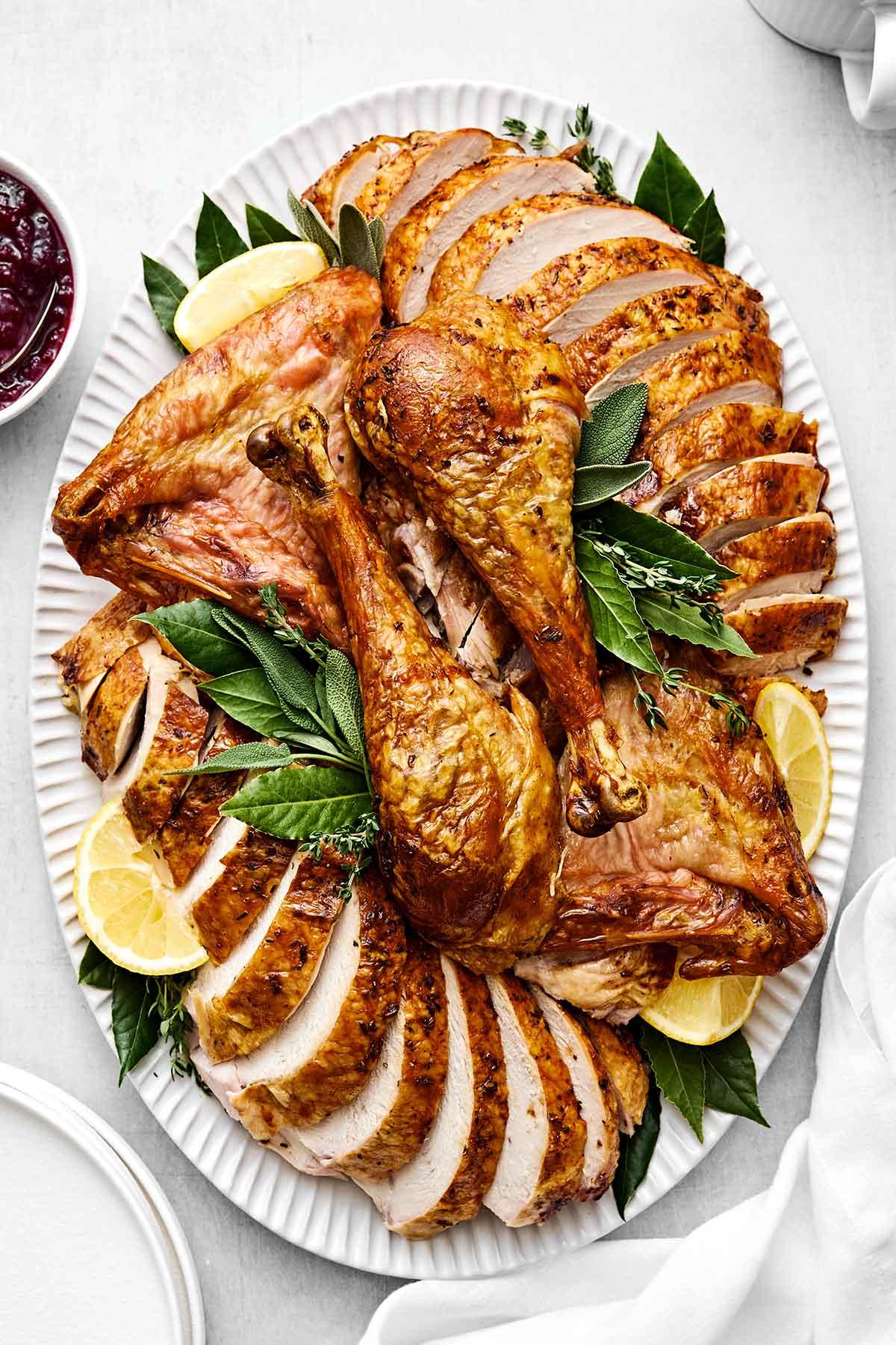 carved honey thyme turkey slices on a platter, showing juicy, soft texture
