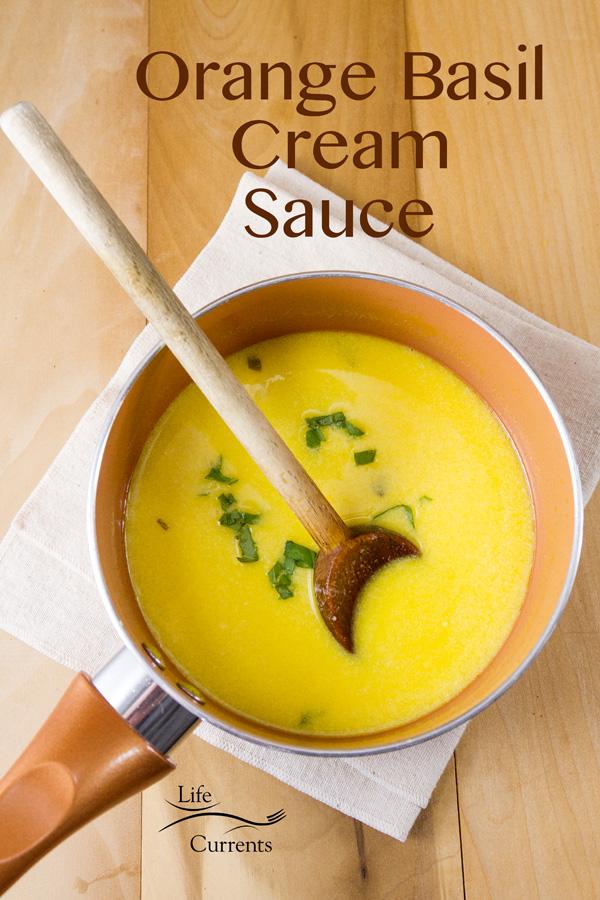 Close-up of a bowl of creamy, orange secret sauce with fresh herbs