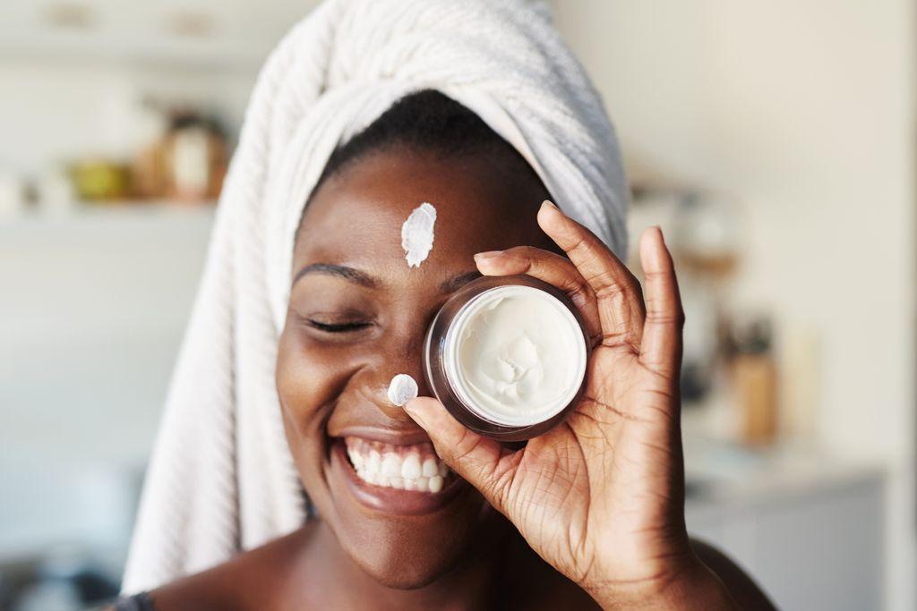 woman applying skincare products mindfully