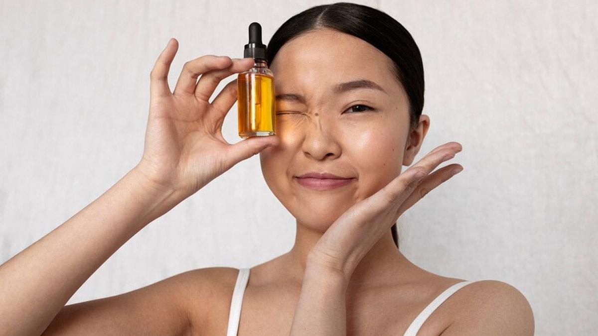 woman applying facial oil at night