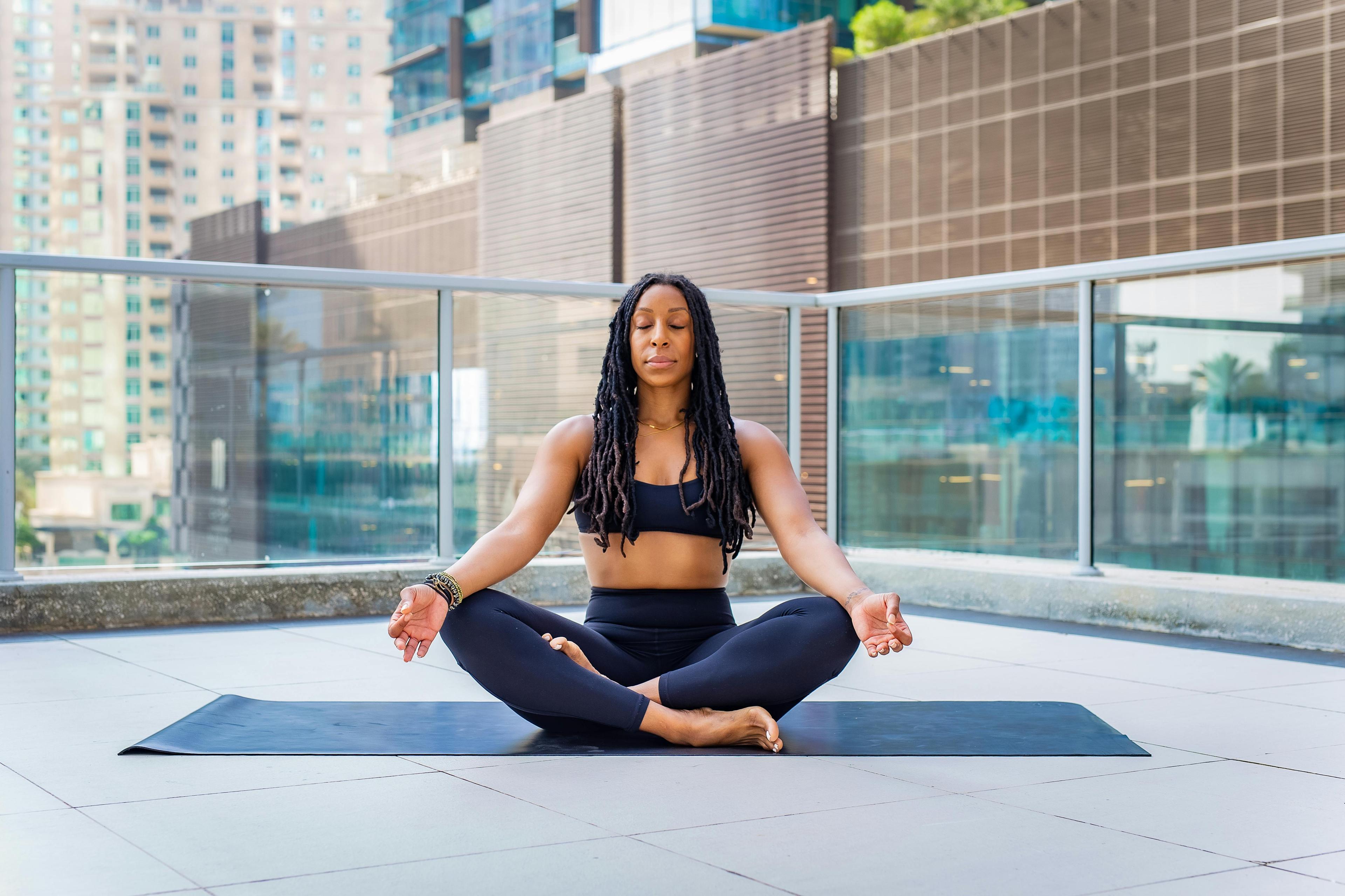 woman meditating on a yoga mat