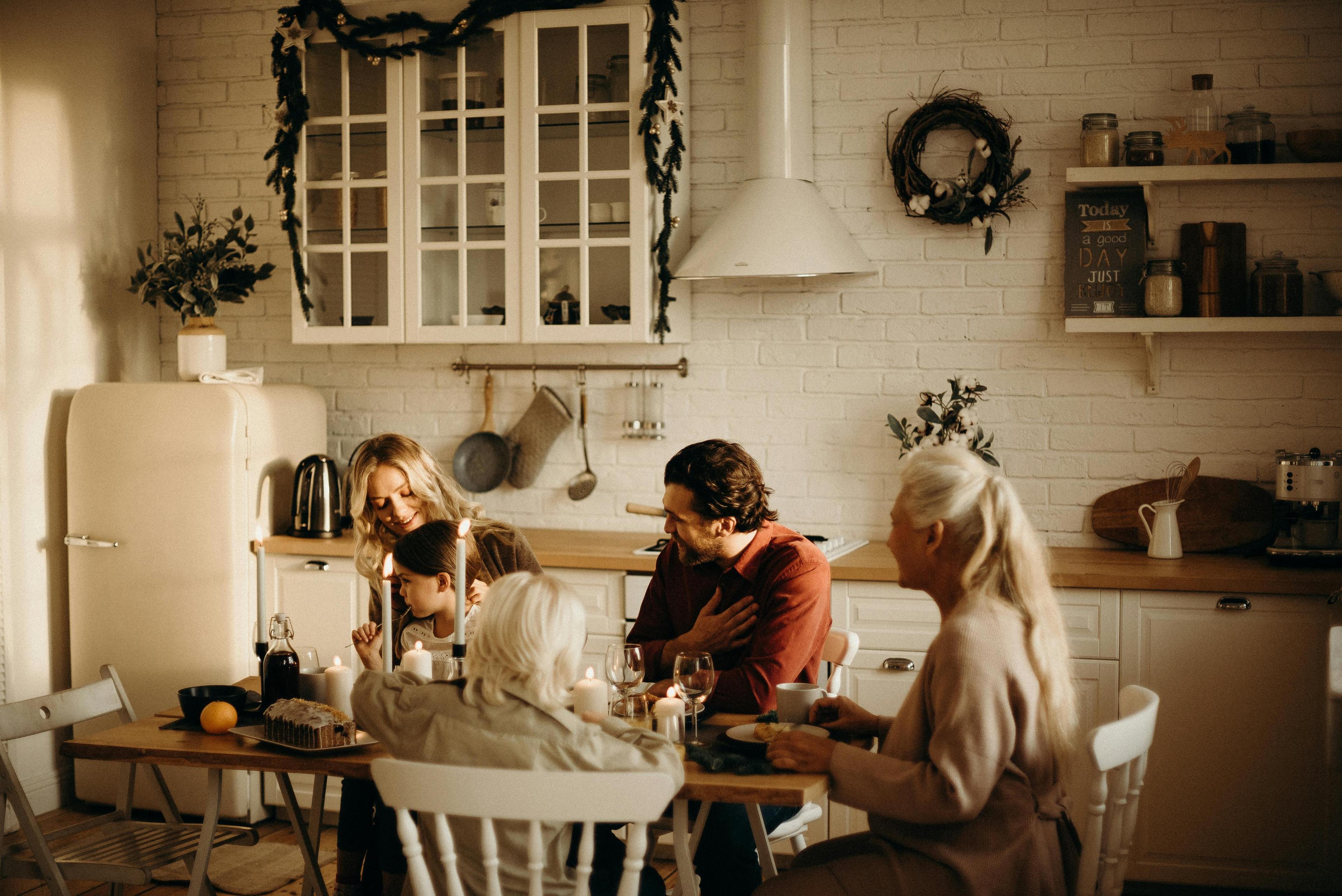 Cozy kitchen scene with a family enjoying a Tuscan-style meal, warm lighting