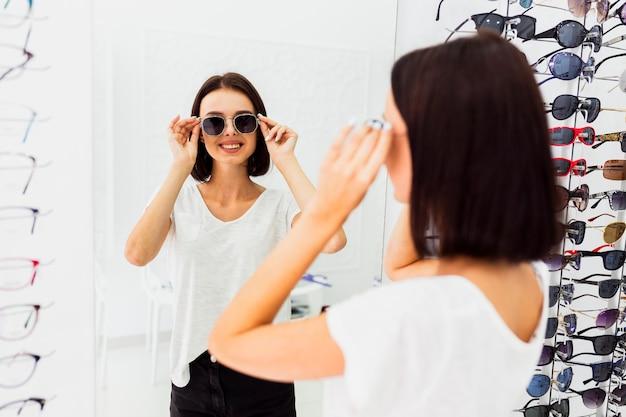 woman trying on sunglasses