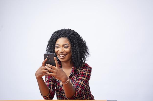 woman looking at her Instagram feed on her phone, smiling