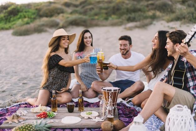 Group of friends enjoying a spontaneous beach party
